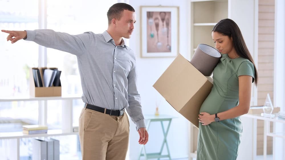 Boss, man and dismissal pregnant woman in office with box, sad and discrimination with inequality in workplace. Business people, manager and fire employee for pregnancy with point at creative startup