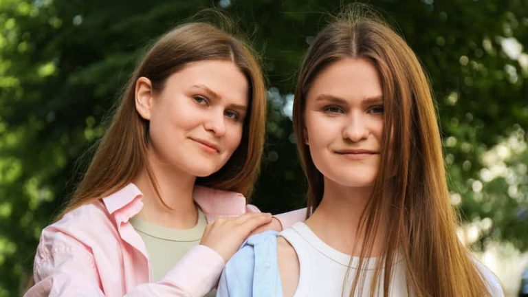 Portrait of two beautiful twin sisters outdoors