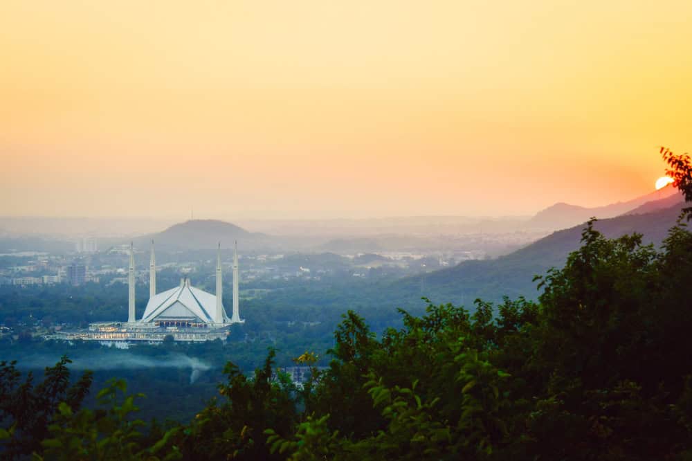 Islamabad, Pakistan - 12th september, 2023: The Faisal Mosque - fifth-largest mosque in the world. Major tourist attraction in Pakistan. Margalla hills famous sunset viewpoint panorama