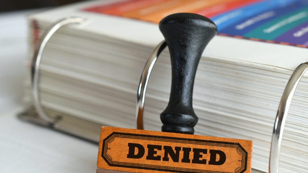 Rubber stamp with word Denied on it. Being turned down rejected refused for a loan or application.