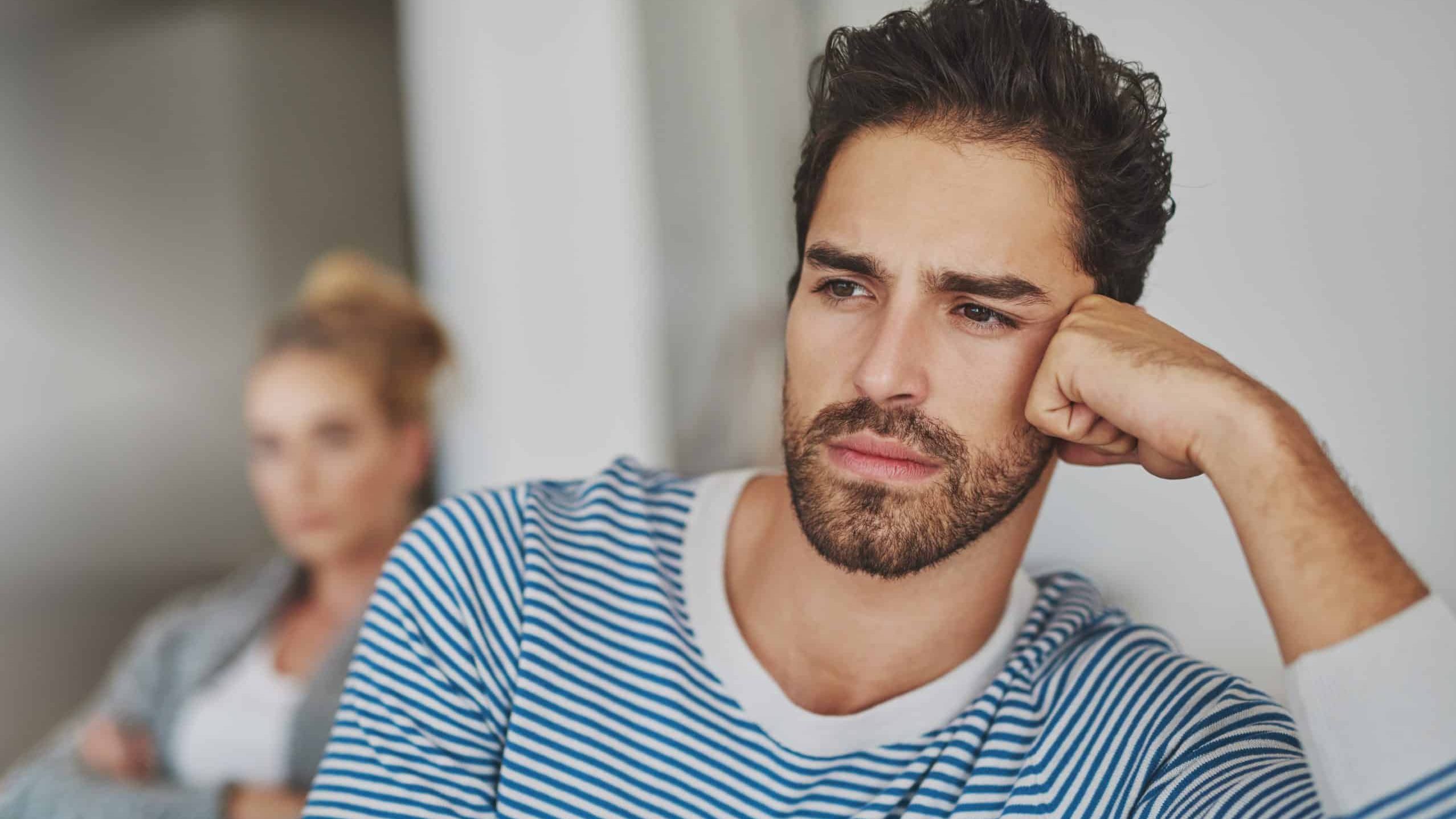 Man, silent and couple conflict in home, disagreement and betrayal or abuse in toxic marriage. People, ignoring and relationship mistake or fail in living room, divorce and stubborn fighting on sofa