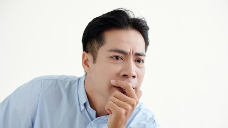 Man Sitting With Pensive Expression