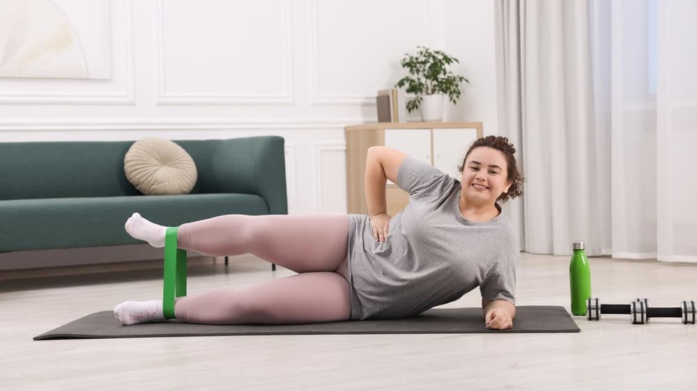 Woman training with resistance band at home