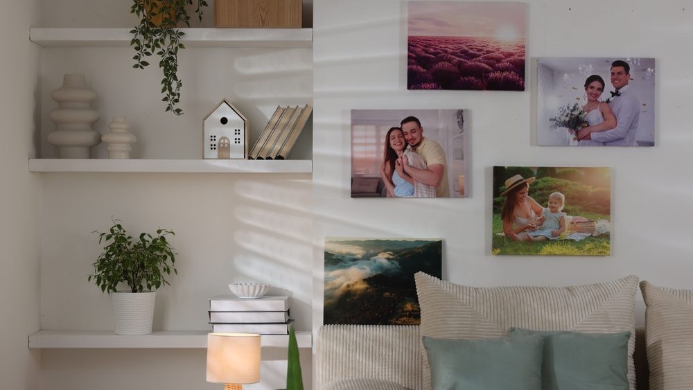 Canvas with different printed photos on white wall indoors