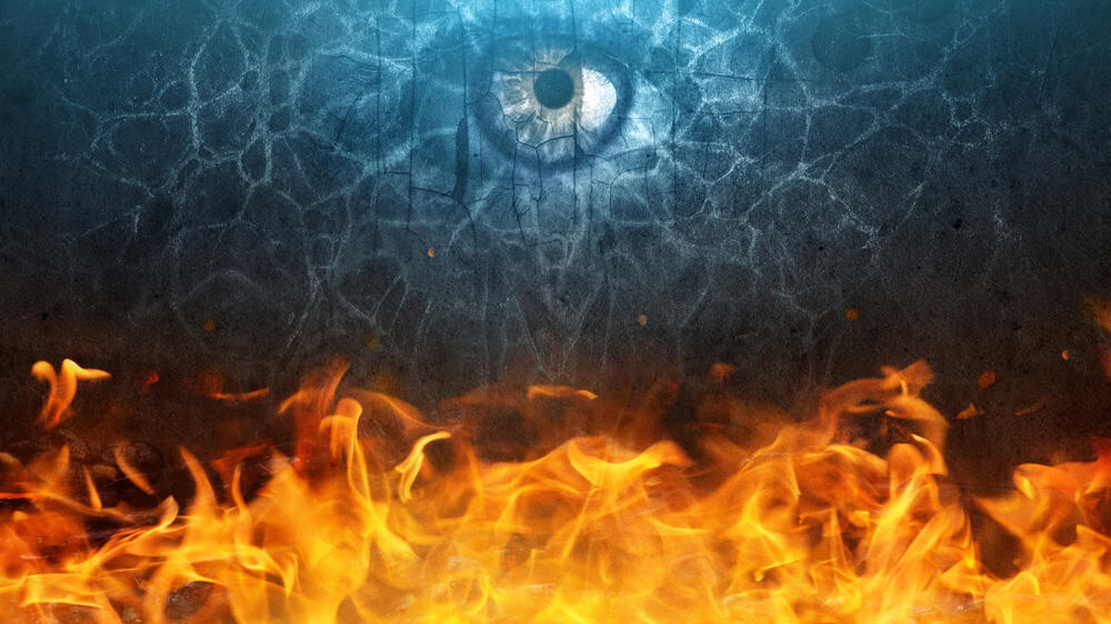 The devil's eye looks out from the darkness. Flame, fire on the background black walls and smoke. Wide background on the theme of horror, hell, Halloween, etc.