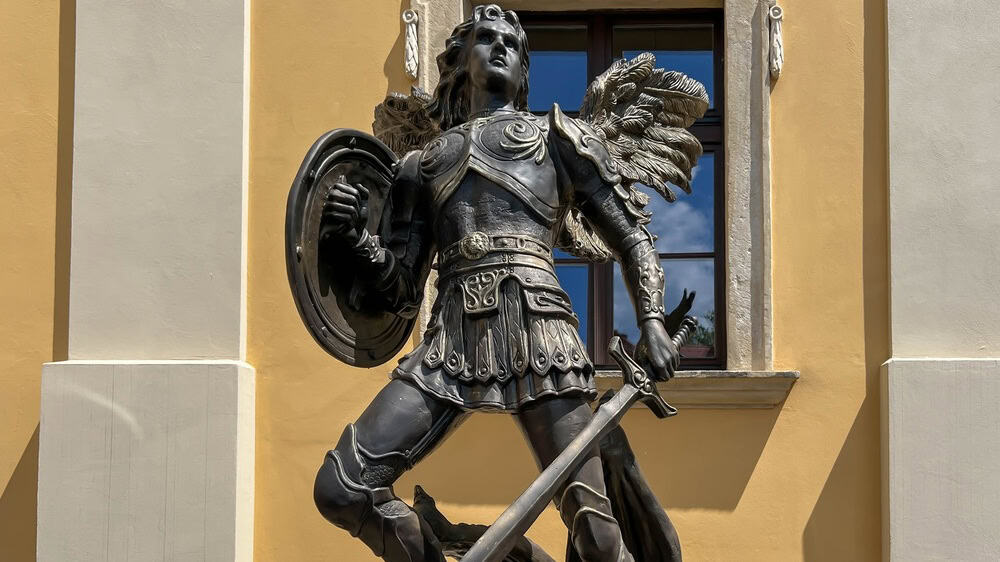 Rudy, Poland, June 24, 2025: Cistercian monastery and palace complex in Rudy, Poland. Exterior of the grounds in front of the buildings. Statue of the Archangel Michael.