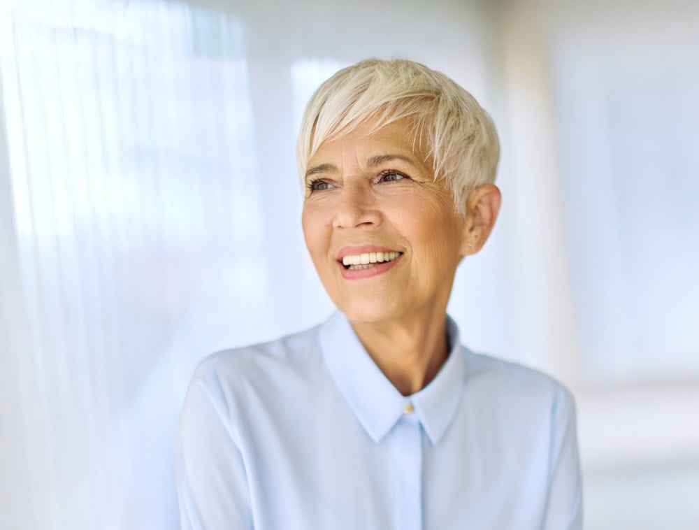 Portrait of an active senior elderly businesswoman during a meeting in the office