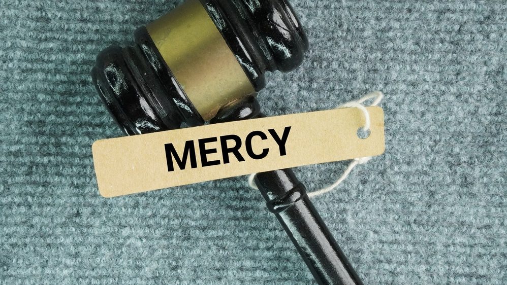 Hammer the judge and tag the paper with the word mercy. kind and forgiving treatment shown to someone when you have the power to punish or harm them. It means choosing not to hurt or punish an opponent, prisoner