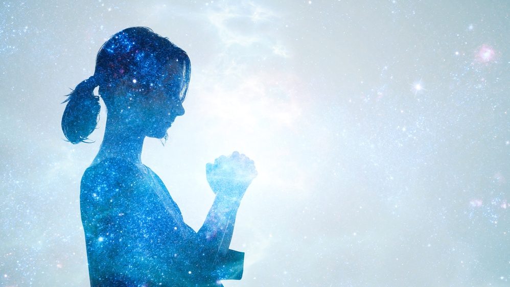 A woman meditating and the concept of mindfulness