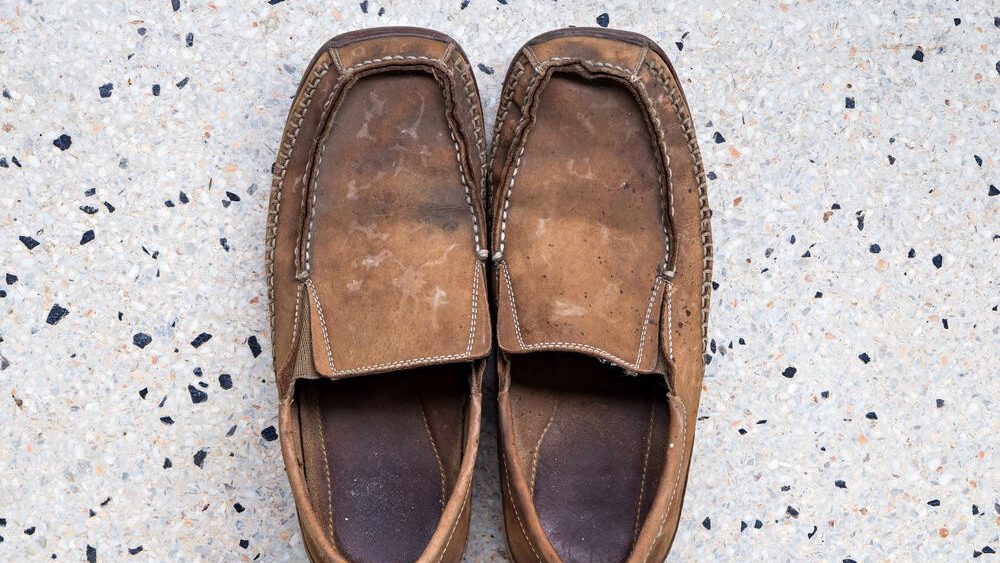 Old leather shoes on terrazzo floor