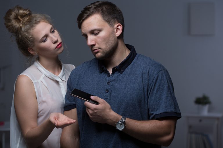 Woman overpowering man and controlling his phone