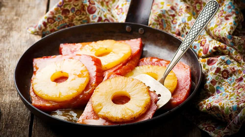 Ham with Pineapple in iron pan.selective focus.style rustic