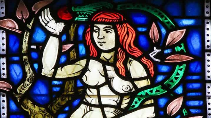 WORMS, GERMANY - JULY 4, 2017: Stained Glass in Wormser Dom in Worms, Germany, depicting Eve and the Snake