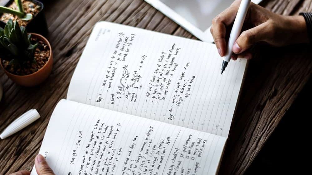 Hand Holding Pen Write Travel Plan Note