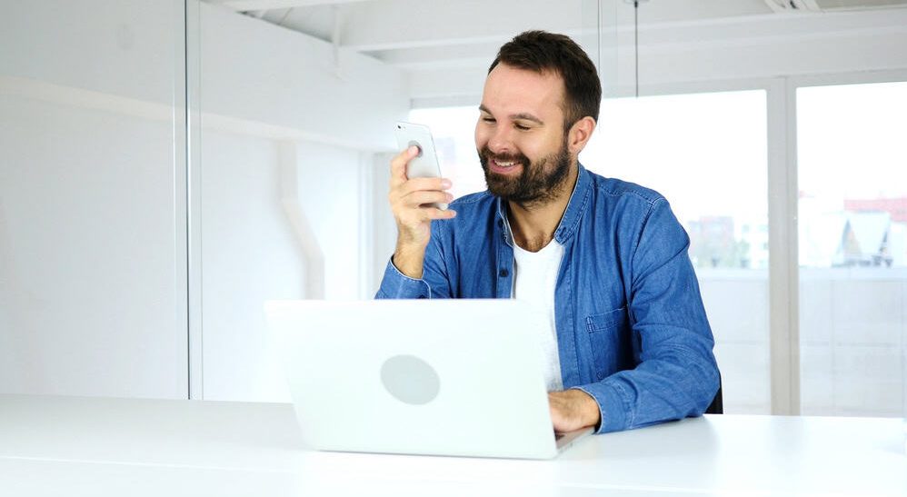 Happy Man Reading Message on Smartphone, Success and Money