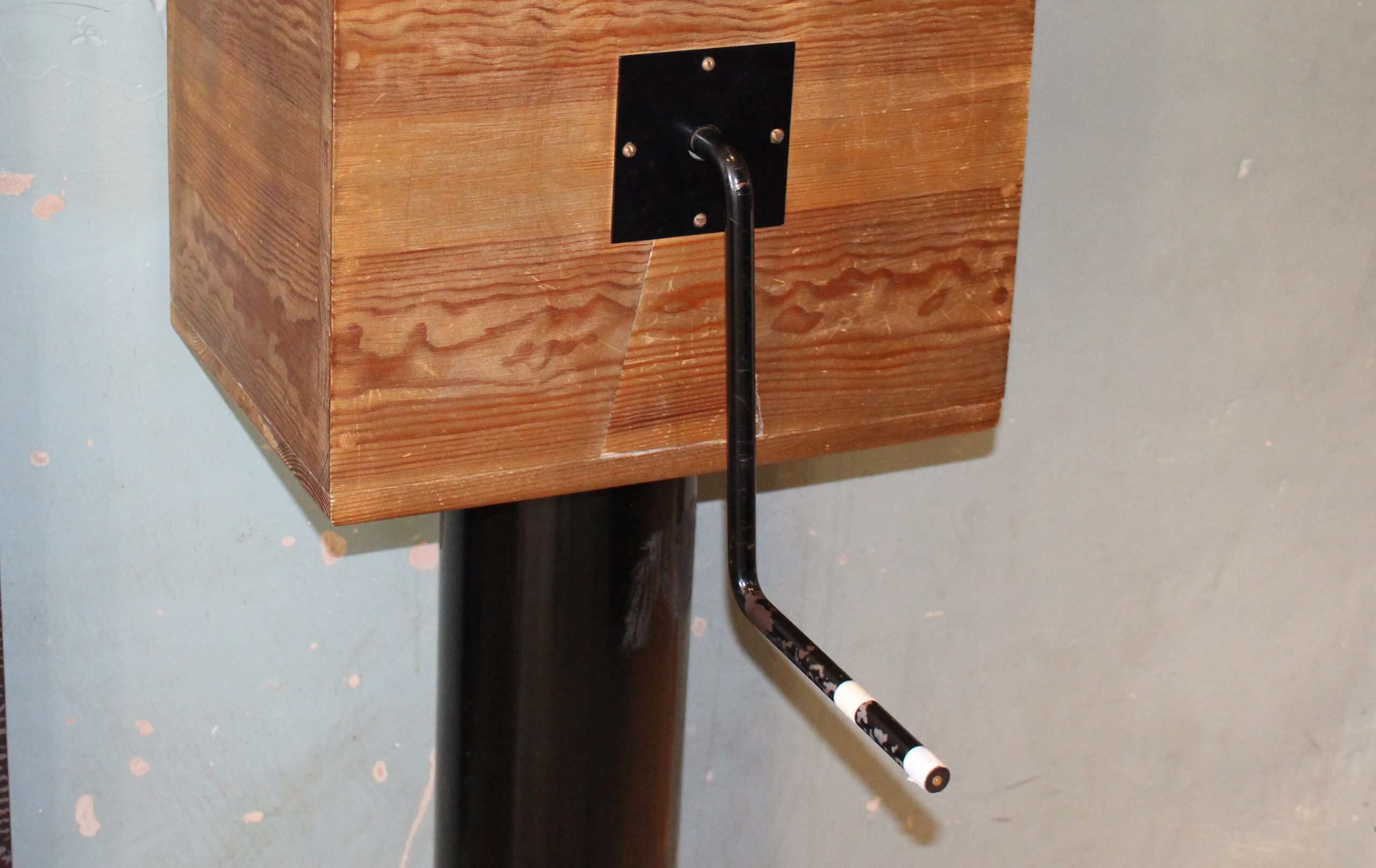 Old punishment device with a lever and wooden structure.