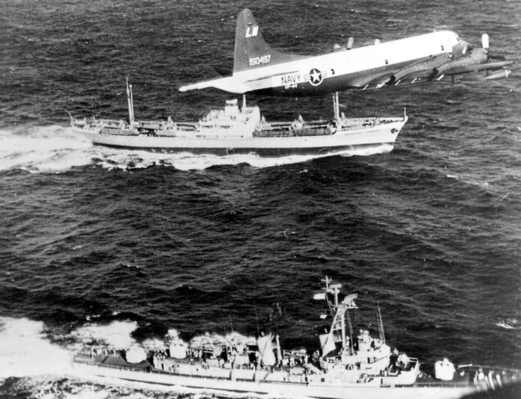 A U.S. Navy Lockheed P-3A-20-LO Orion (BuNo 150497) of Patrol Squadron VP-44 flies over the Soviet ship Metallurg Anosov and destroyer USS Barry (DD-933) during the Cuban Missile Crisis.