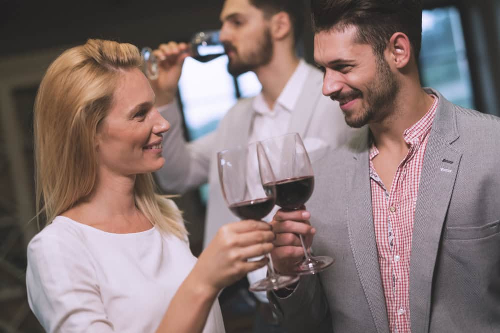 Flirting woman at party with jealous partner