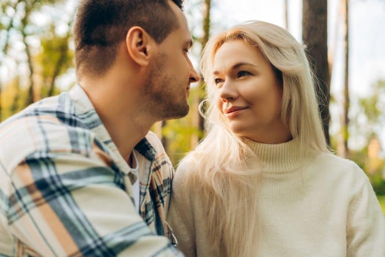 Attractive, beautiful couple, attractive woman and man looking each other, relaxing outdoors. Love,
