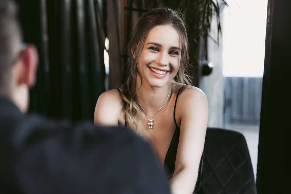 Young woman smiling on a date with her husband in a restaurant. High quality photo