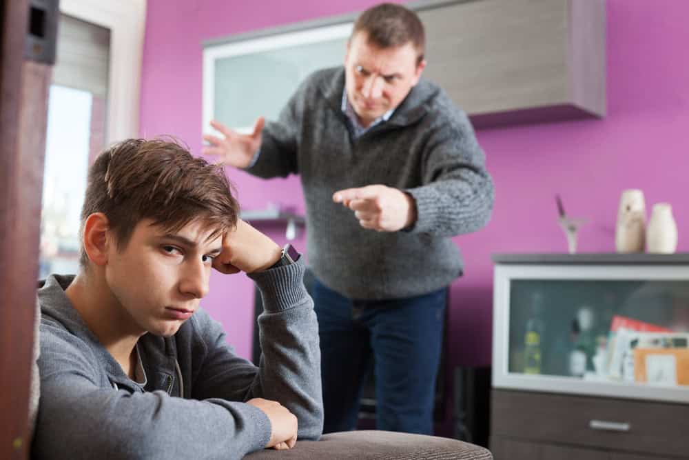 Angry father screaming at offender son