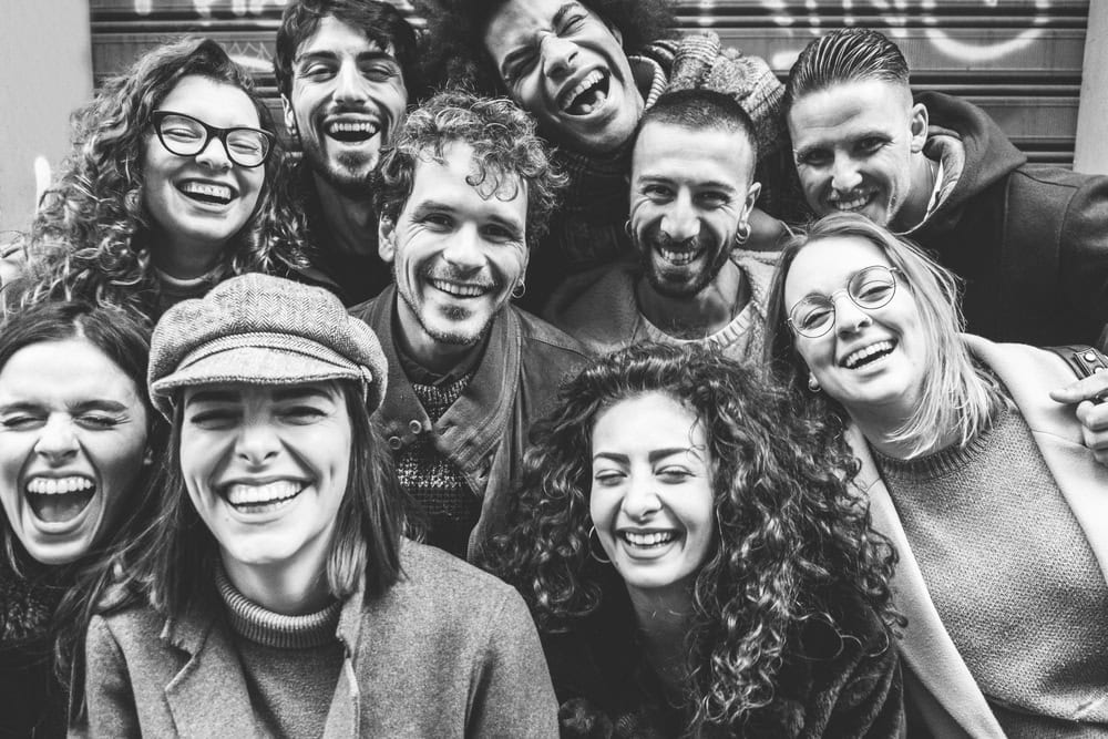 Happy friends from diverse cultures and races taking posing in front of phone camera - Students having fun at erasmus university - Youth and friendship concept - Soft focus on man with curly hair