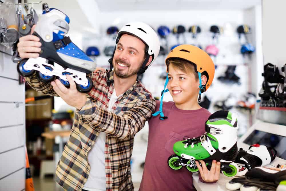 Customers are buying rollers in sports store.
