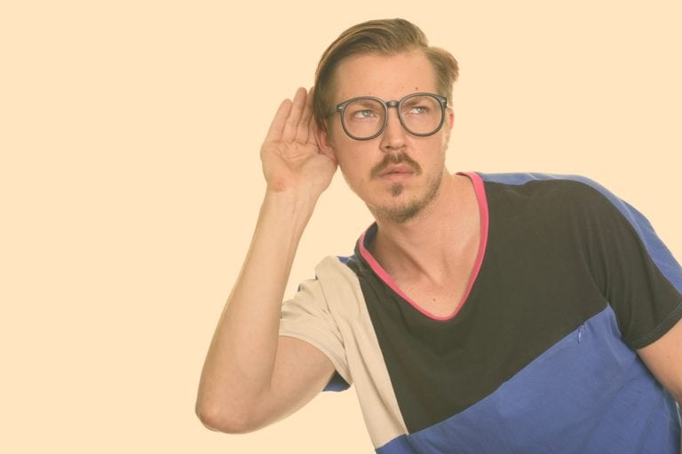 Studio shot of young handsome bearded Scandinavian man as nerd isolated against white background