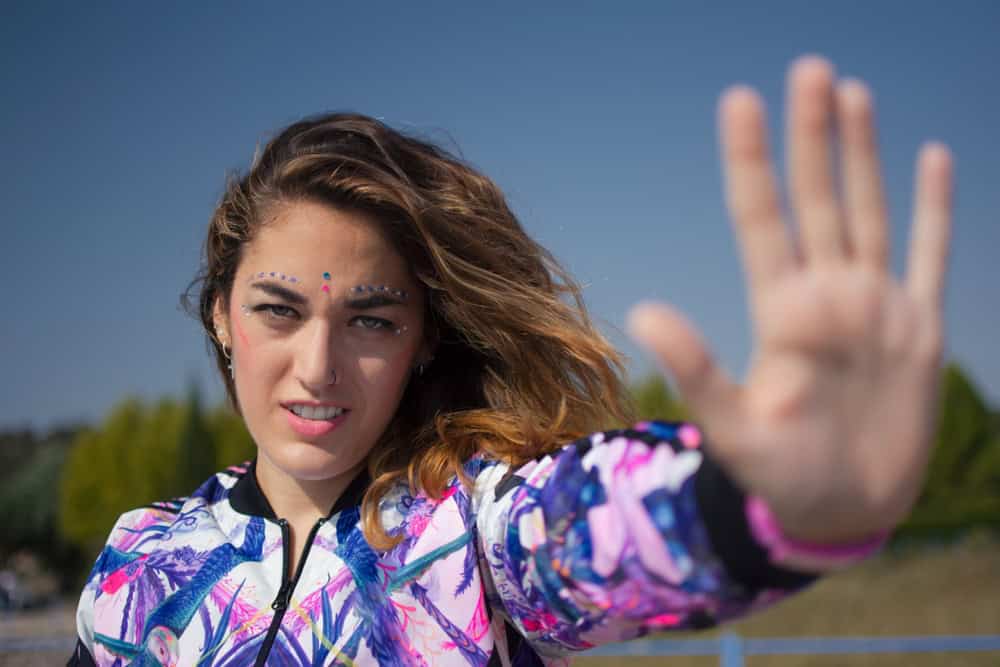 Beautiful girl saying stop with her hand