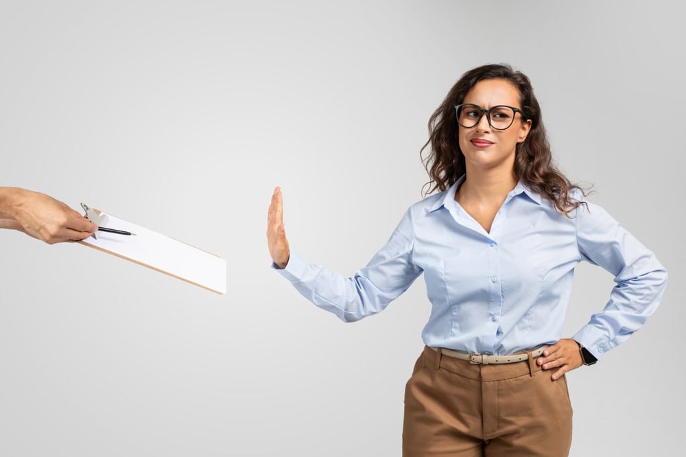 Dissatisfied sad adult european woman in formal wear making stop sign with hand for signing contract, isolated on gray background studio background. Problems with work, bad deal