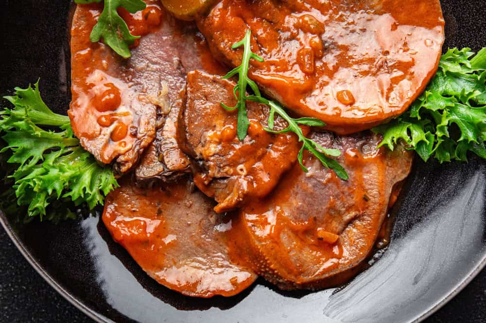 Beef tongue hot sauce fresh delicious eating meal cooking appetizer food snack on the table copy space food background rustic top view keto or paleo diet