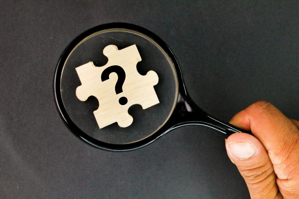 magnifying glass and puzzle with question mark symbol. the concept of finding a problem. Business answer and analysis, problem ask, interrogation, research information concept.