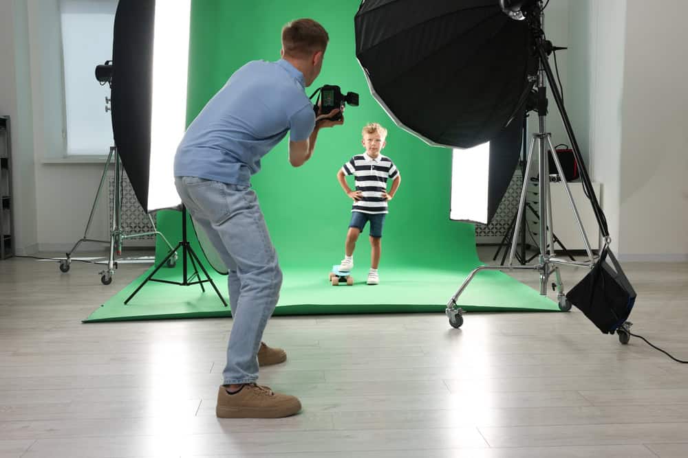 Photographer working with model in professional photo studio