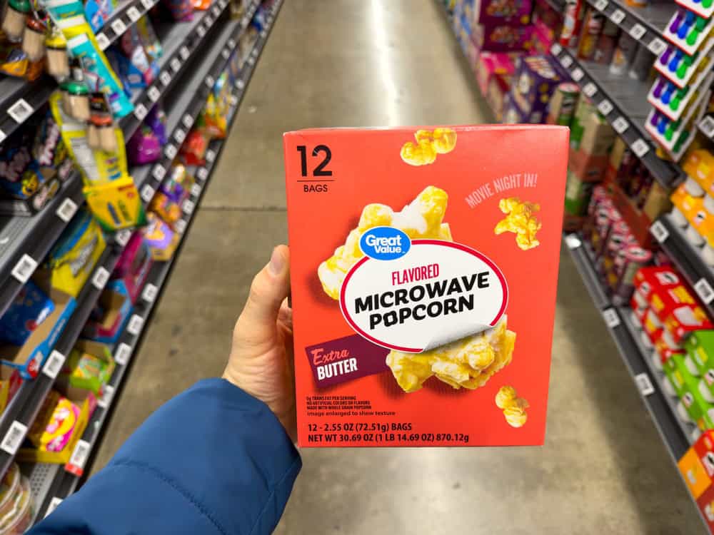 Los Angeles, CA - January 9, 2026: Great Value Butter Microwave Popcorn Box Held In Grocery Store Aisle.