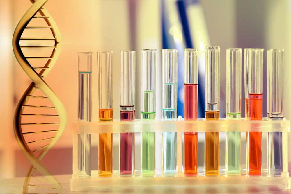 Test tubes on table in laboratory and DNA strand, color toned. Research in biochemistry and genetics