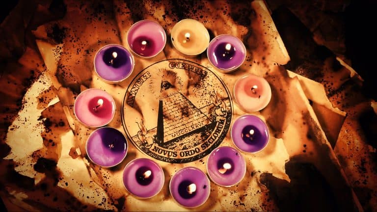 An ancient paper featuring the printed Masonic All Seeing Eye symbol, beautifully surrounded and illuminated by glowing burning candles creating a mysterious, ritualistic, and esoteric atmosphere for secret society concepts.