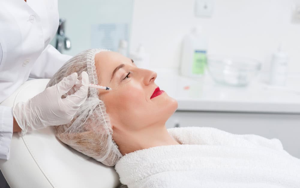 Pretty senior lady is visiting beauty surgeon