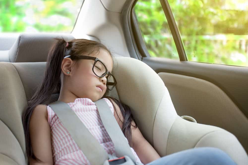 little girl sleeping in child car seat