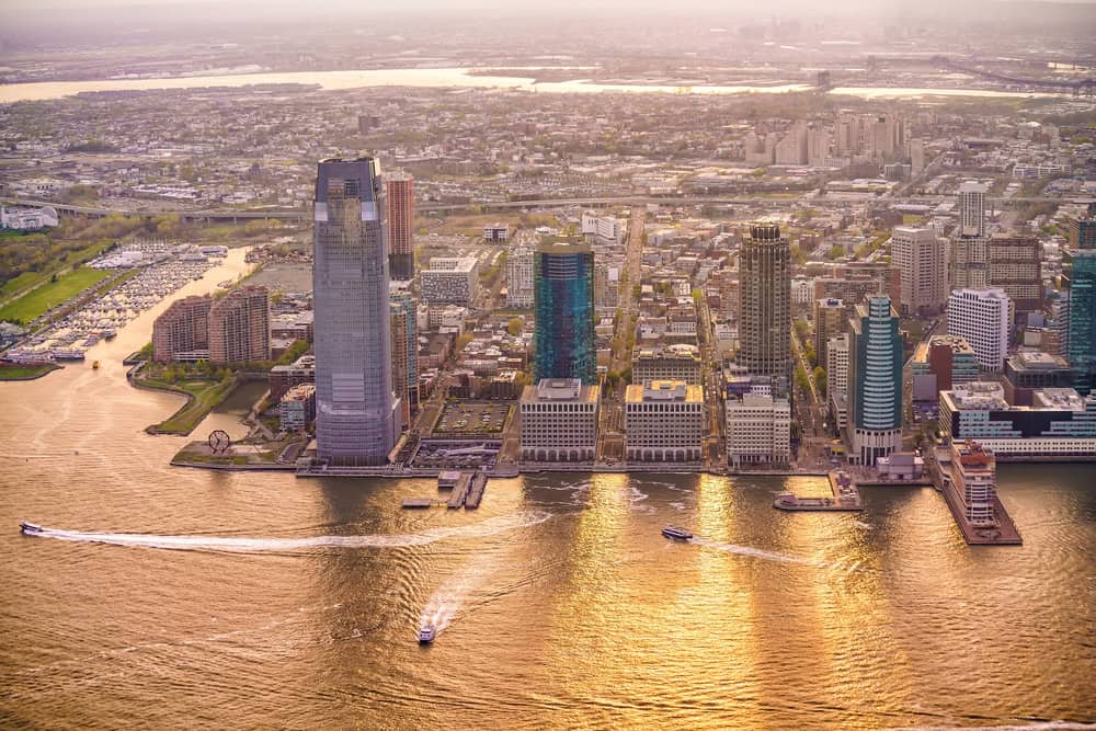View of Jersey City from NY at sunset .