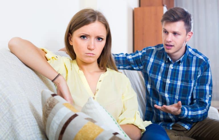Unhappy person criticizing young spouse in living room