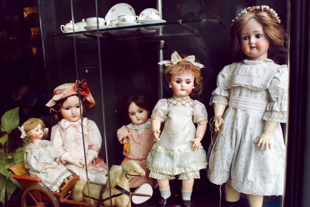 Old porcelain dolls at the shop window in the Lisbon, Portugal.