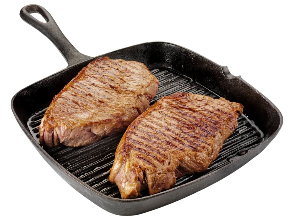 Two Beef Steaks Cooking in Pan Cut Out