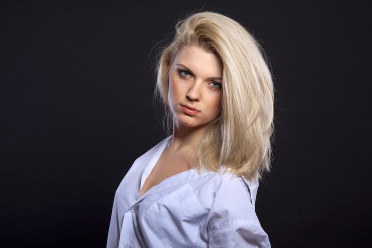 Fashion portrait of sensual blond in man's shirt