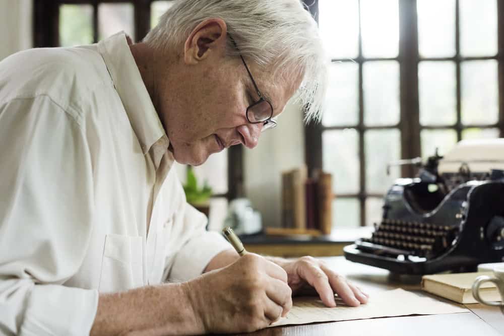 Closeup of senior man writing letter