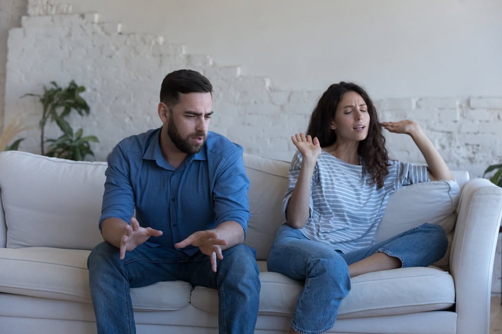Angry couple talking in emotional conflict, arguing, shouting. Annoyed worried husband and wife disp