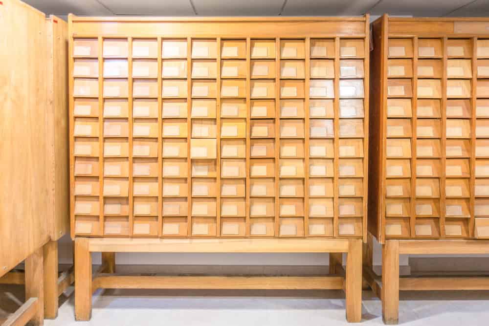Old vintage file catalog boxes with many wooden index drawers in library archive