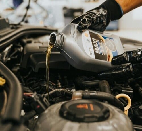 Mechanic performing oil change in Lower Sackville NS