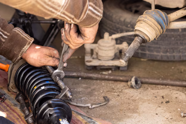 calloused-hands-mechanic-compressing-coil-spring-diy-car-repairs_636705-23367 (1)