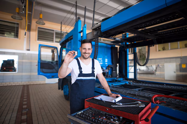 experienced-middle-aged-truck-mechanics-holding-parts-tools-repair-shop-by-truck