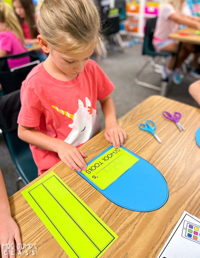 A young girl completes a paper backpack craft